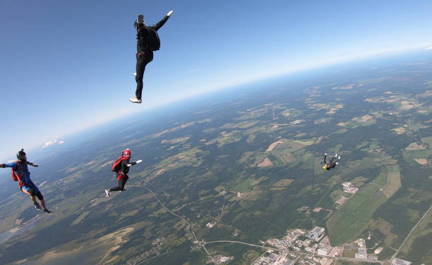 istock Skydivers fall through clear skies, aerial flight 1176963294