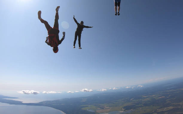 istock Skydivers fall through clear skies, aerial flight 1176963300