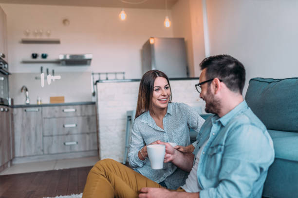 istock Two people talking while having cup of coffee at home. 1176963434