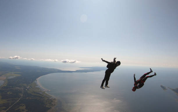 istock Skydivers fall through clear skies, aerial flight 1176963643