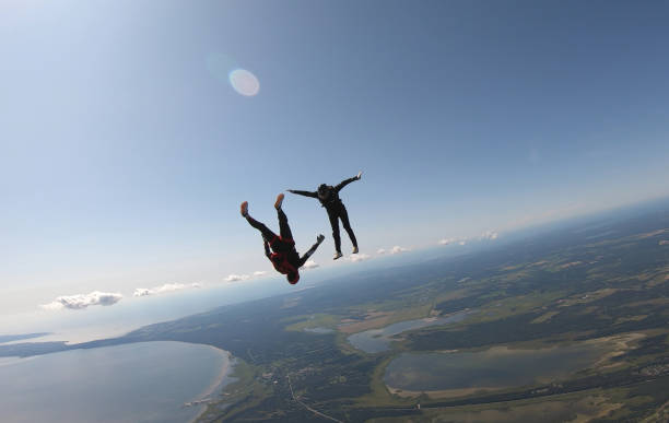 istock Skydivers fall through clear skies, aerial flight 1176963661