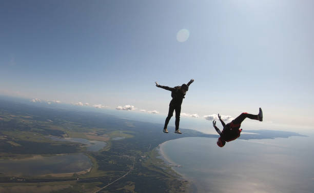 istock Skydivers fall through clear skies, aerial flight 1176963700