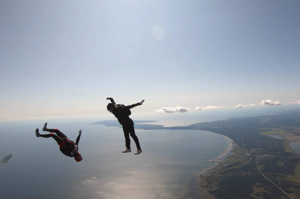 istock Skydivers fall through clear skies, aerial flight 1176964145