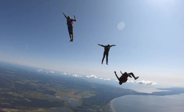 istock Skydivers fall through clear skies, aerial flight 1176964259