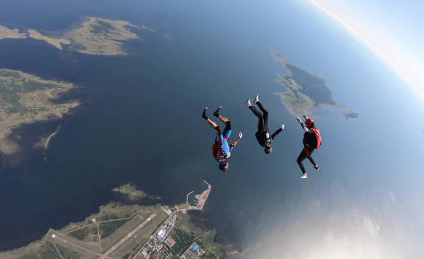 istock Skydivers fall through clear skies, aerial flight 1176964932