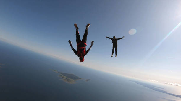 istock Skydivers fall through clear skies, aerial flight 1176965576