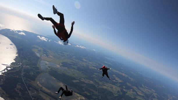 istock Skydivers fall through clear skies, aerial flight 1176965588