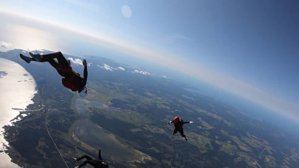 istock Skydivers fall through clear skies, aerial flight 1176965628