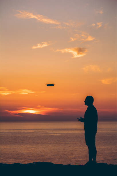 istock Silhouette of man with drone 1176965697