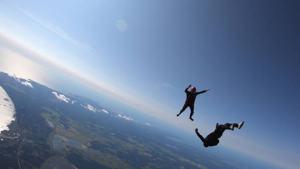 istock Skydivers fall through clear skies, aerial flight 1176965786