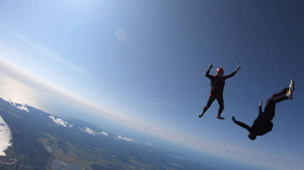 istock Skydivers fall through clear skies, aerial flight 1176966061