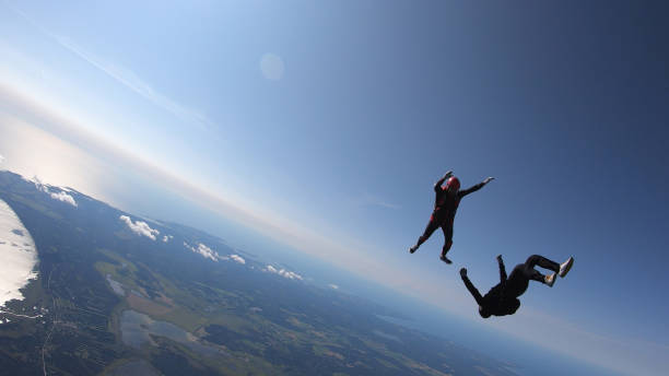 istock Skydivers fall through clear skies, aerial flight 1176966107