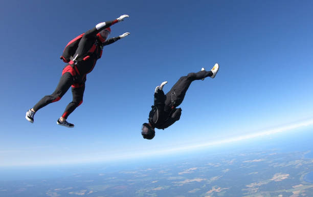 istock Skydivers fall through clear skies, aerial flight 1176966326