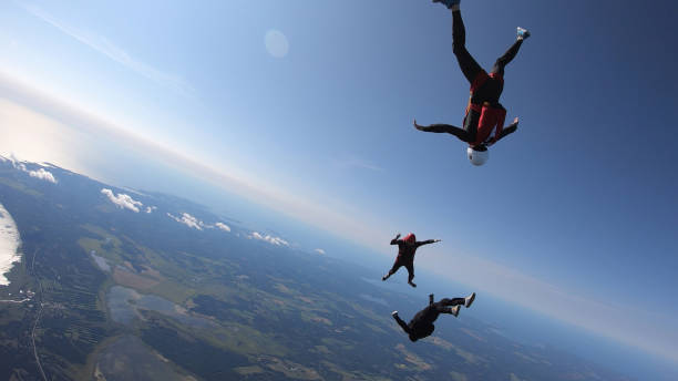 istock Skydivers fall through clear skies, aerial flight 1176966334
