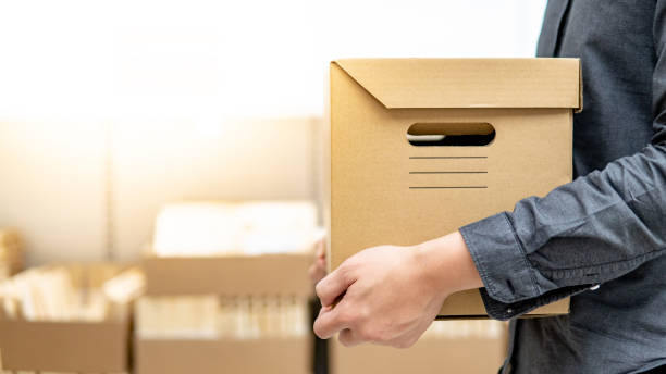 istock Courier man carrying box shopping in warehouse 1176969608