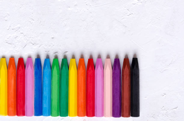 istock Multicolored pastel crayons, white table.Hobby stuff for children 1176970678