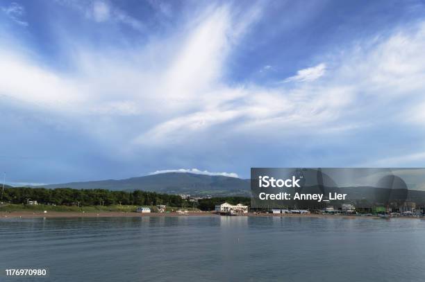 Majestic Cloudscape Over Hallasan Mountain And Jeju Island With View On Iho Tewoo Beach Stock Photo - Download Image Now