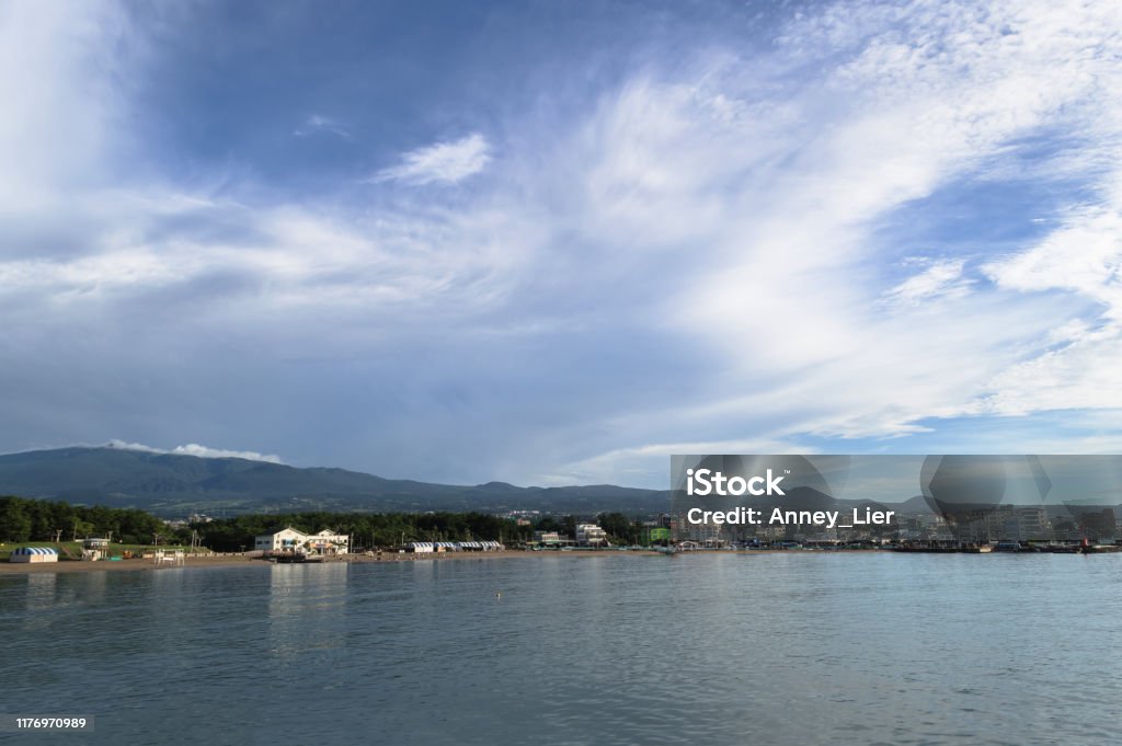view form nearby pier on Iho Tewoo Beach and lanscape of jeju island with scenic cloudscape Adventure Stock Photo