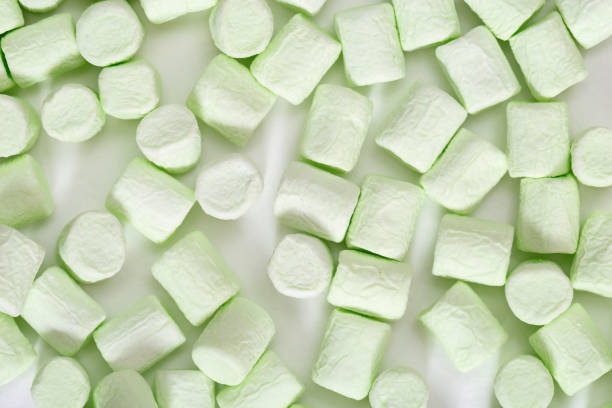 istock Marshmallow pattern. Gentle Green mini zephyr pastel colored. Winter concept. Sweet food background. Top view. 1176971292