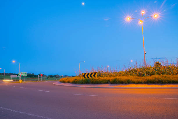 Intersection and roundabout at Papamoa Tauranga in morning light with direct sign to Te Puke and Tauranga New Zealand.