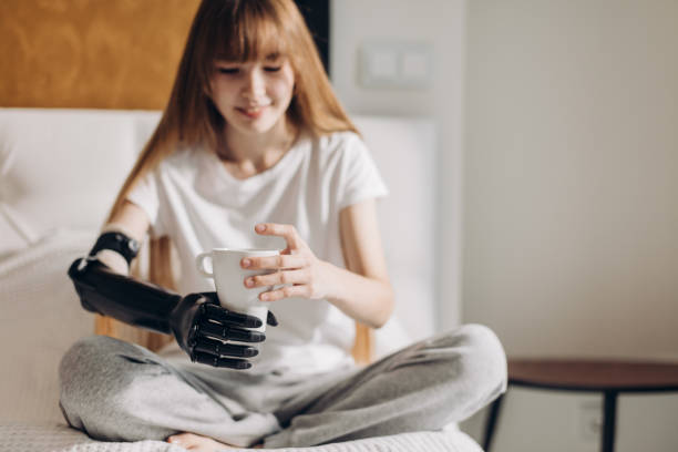 istock smiling girl with prosthetic cyber arm holding a cup 1176972088