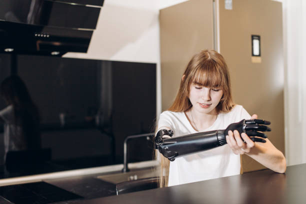 istock disabled girl checking her matal prosthetci arm 1176972223