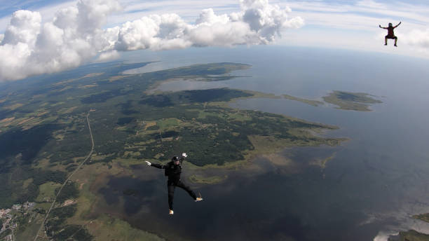 istock Skydivers fall through clear skies, aerial flight 1176972447