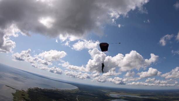 istock Paraglider moves through clear skies, aerial flight 1176972941