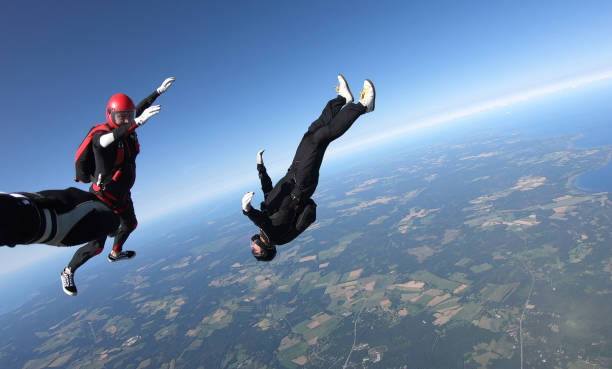 istock Skydivers fall through clear skies, aerial flight 1176973579