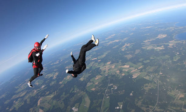 istock Skydivers fall through clear skies, aerial flight 1176973592