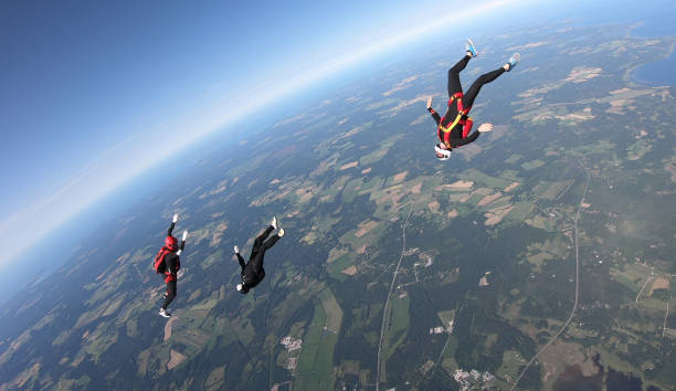 istock Skydivers fall through clear skies, aerial flight 1176973624