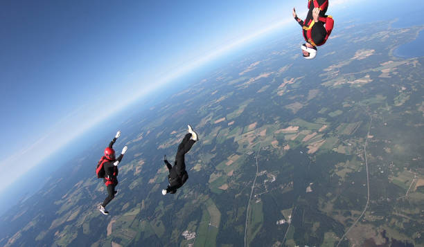 istock Skydivers fall through clear skies, aerial flight 1176973625