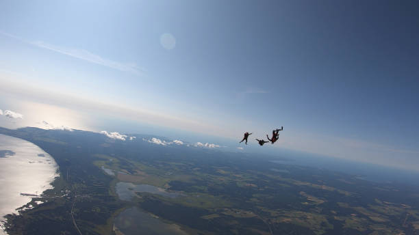 istock Skydivers fall through clear skies, aerial flight 1176973656