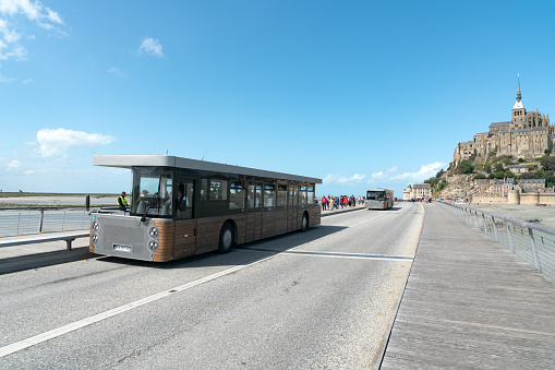 Le Mont Saint-Michel, Manche / France - 18 August 2019: bus transport for tourists visiting the famous Mont Saint-Michel in France