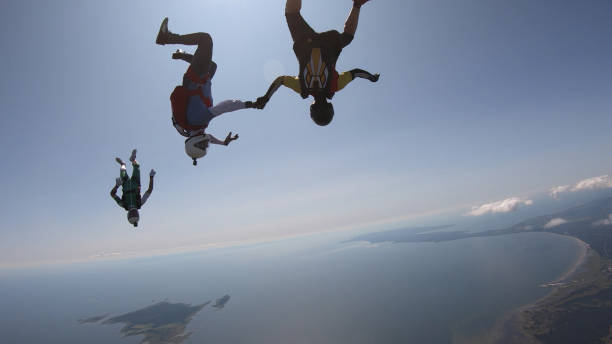 istock Skydivers fall through clear skies, aerial flight 1176973947