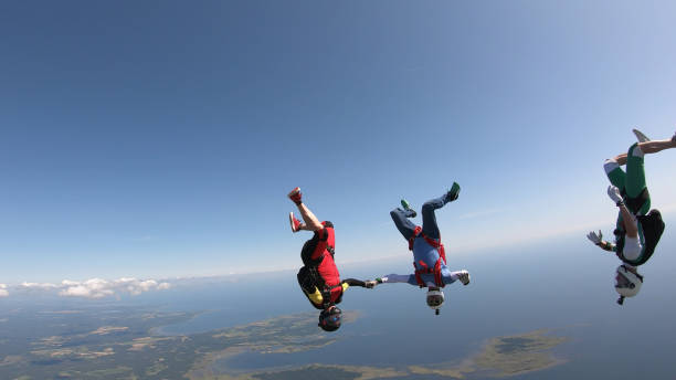 istock Skydivers fall through clear skies, aerial flight 1176974047
