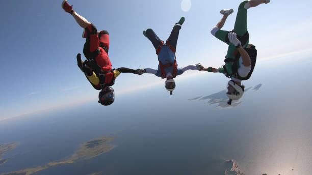 istock Skydivers fall through clear skies, aerial flight 1176974120