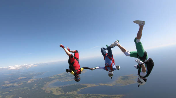 istock Skydivers fall through clear skies, aerial flight 1176974152