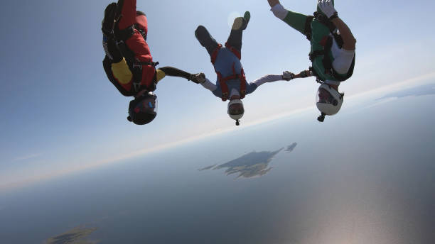 istock Skydivers fall through clear skies, aerial flight 1176974235