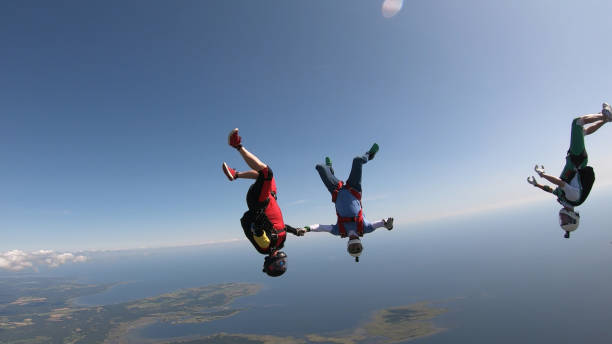 istock Skydivers fall through clear skies, aerial flight 1176974453