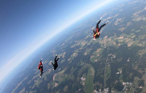 istock Skydivers fall through clear skies, aerial flight 1176975164