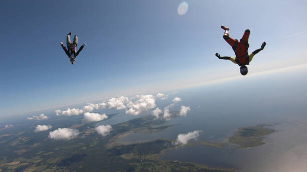 istock Skydivers fall through clear skies, aerial flight 1176975304