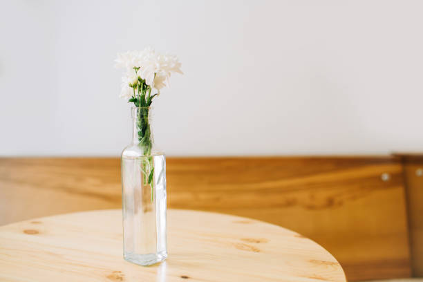istock White flowers in a vase on white background. 1176976360