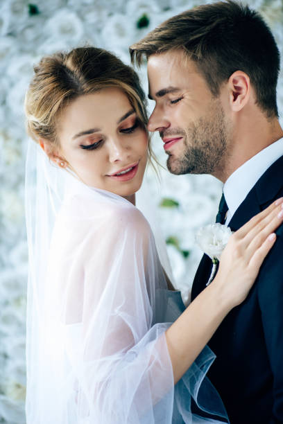 istock attractive bride and handsome bridegroom hugging with closed eyes 1176977193