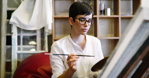 istock Beautiful young woman attending a painting workshop 1176977312
