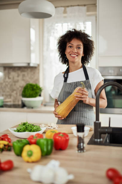 istock Mixed race woman holding zucchini. 1176978456