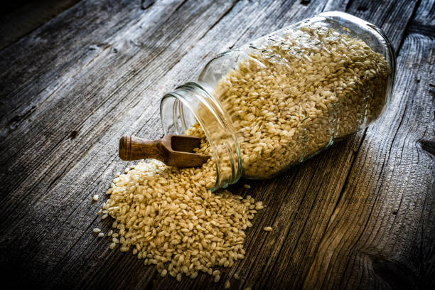 istock Wholegrain rice in glass jar on rustic wooden background 1176979193