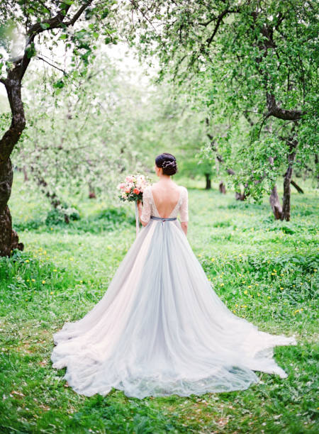 istock beautiful bride in white wedding dress with a bouquet 1176979532