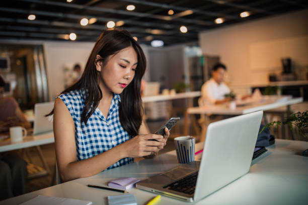 istock Young Taiwanese woman in modern office 1176980456