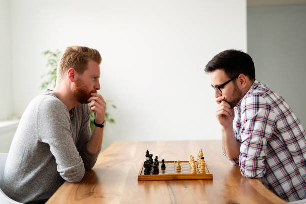 istock Portrait of two young man playing chess 1176982305